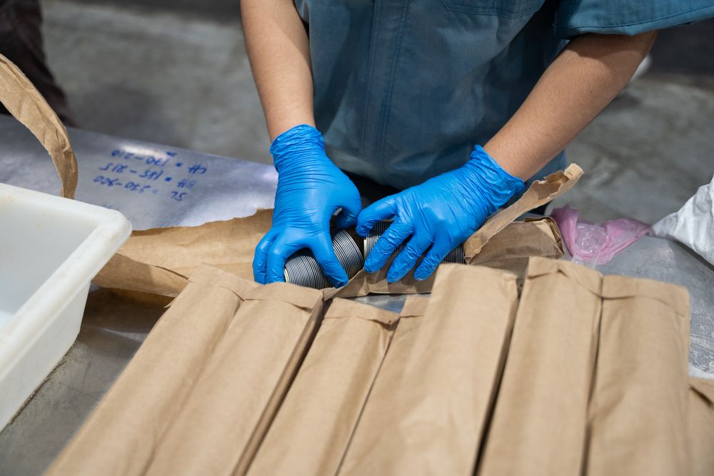 Hand of industrial worker preparing equipment at canned food factory