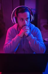 Man listening cheerfully to music with headphones.