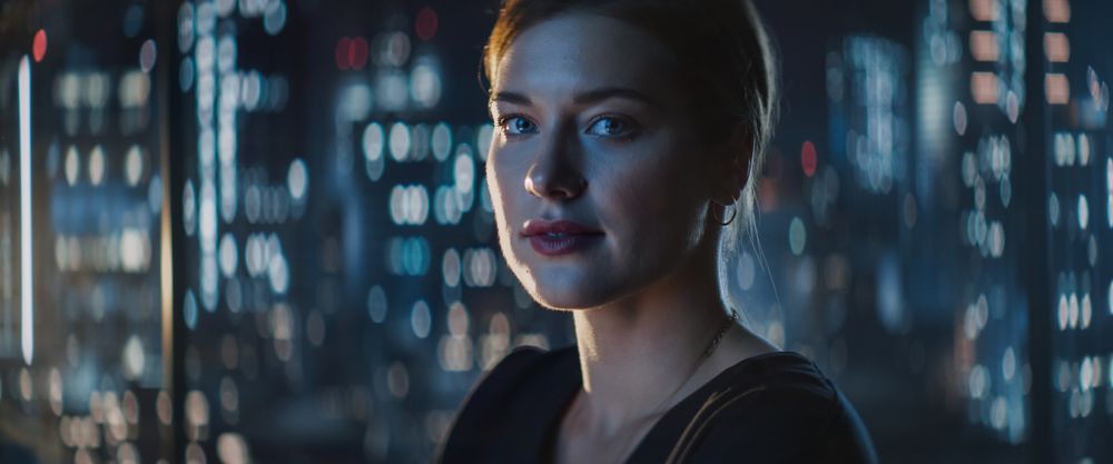 Close Up Portrait of Businesswoman Posing Next to Window in Big City Office with Skyscrapers Late At Night.