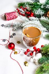 Christmas tree branch with cup of warming coffee