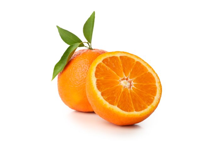 Ripe mandarin with leaves isolated on light background