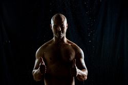 Cheerful bald man under rain