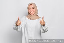 Asian female in headscarf with both thumbs up 5ze3A0