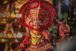 Indian man performing Theyyam ritual form of dance worship