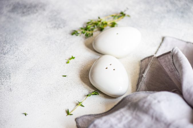 Salt and pepper shakers on marble background