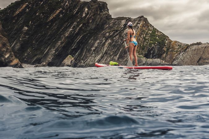 Woman on paddleboard floating in sea