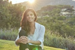 Joyful woman sitting in nature