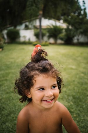 young girl with parrot on her head