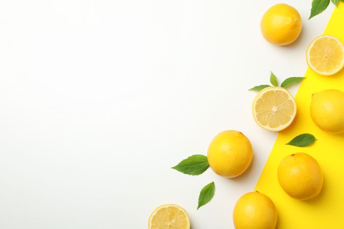 Fresh lemons on two tone background, top view. Ripe fruit