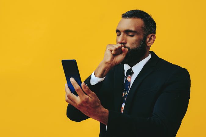 Nervous Black businessman having a video call on a smartphone screen