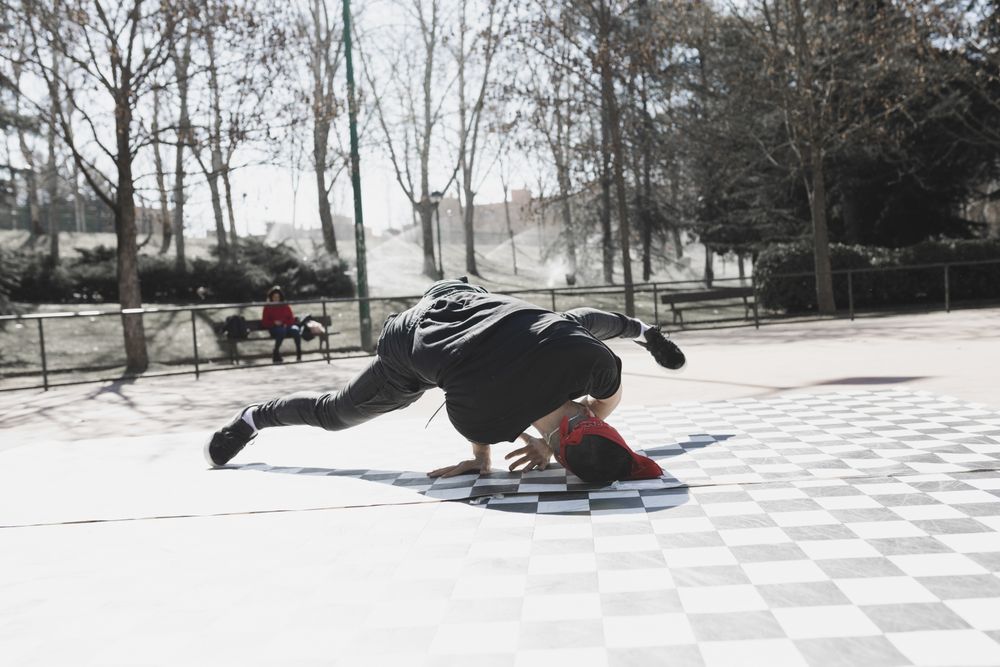 Man dancing break dance in park
