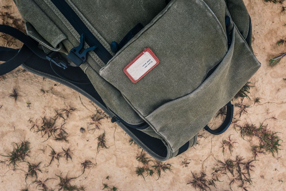 Shabby backpack on dry cracked desert area
