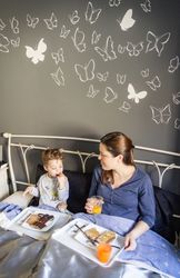 Mother and son having breakfast in bed