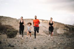 Active diverse family running on nature