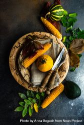 Top view of rustic autumnal table setting with mini squash, corn and leaves 4dZLn0