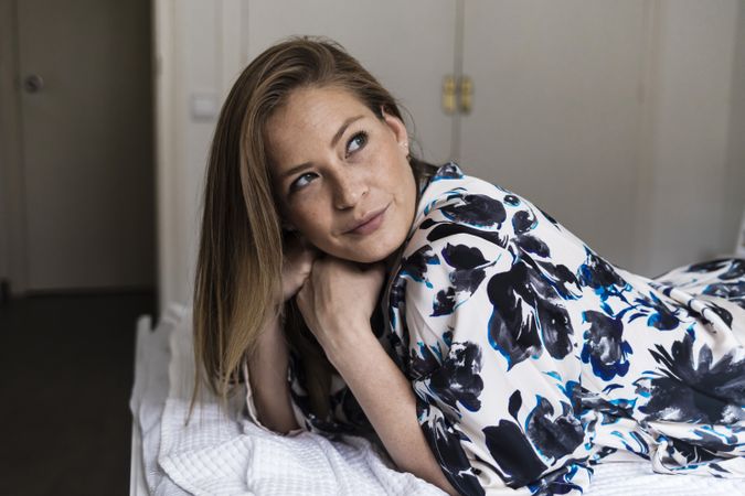 Woman in floral robe relaxing at home