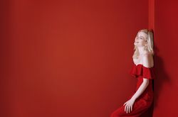 Beautiful young adult woman wearing red jumpsuit