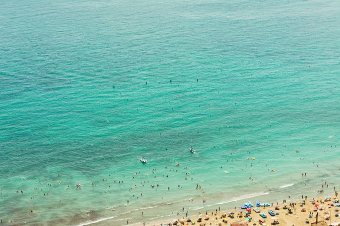 Serene turquoise sea with light waves and beach