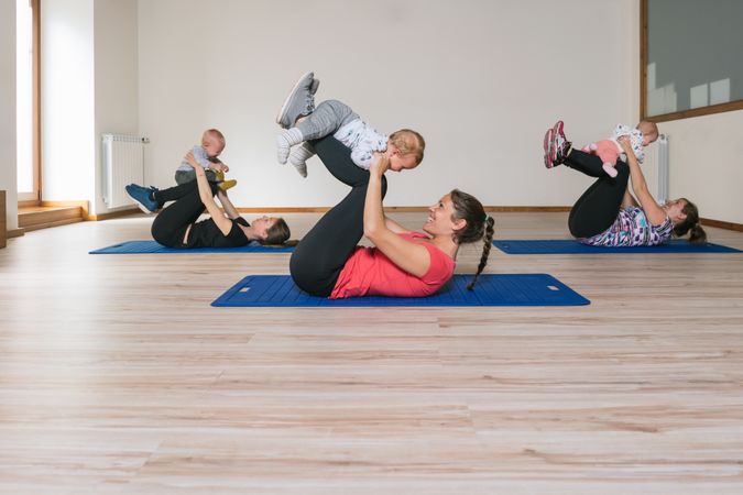 Mothers exercising with babies in gym