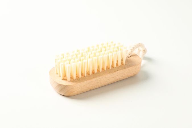 Wooden bath brush isolated on plain background