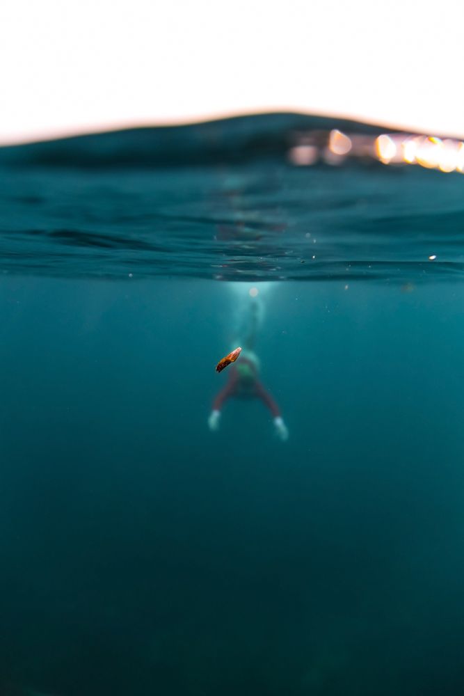 Woman diving in blue water