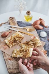 Faceless person with baked onion tart