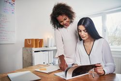 Two designers going over images together