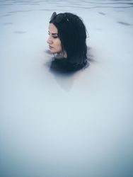 Woman with sunglasses relaxing in a natural spa