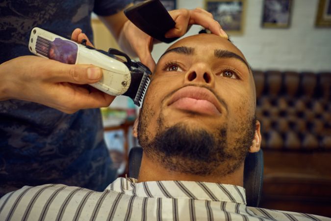 Anonymous hairstylist doing a haircut