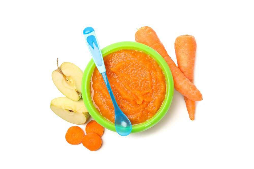 Bowl with vegetable puree on plain background. Baby food