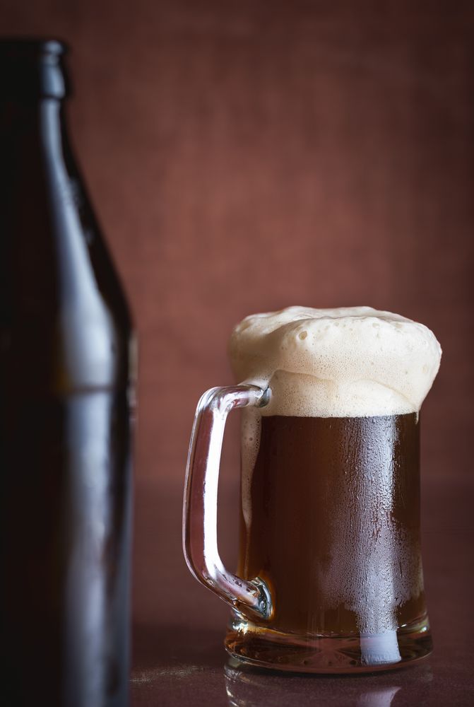 Dark beer in a pint with foam