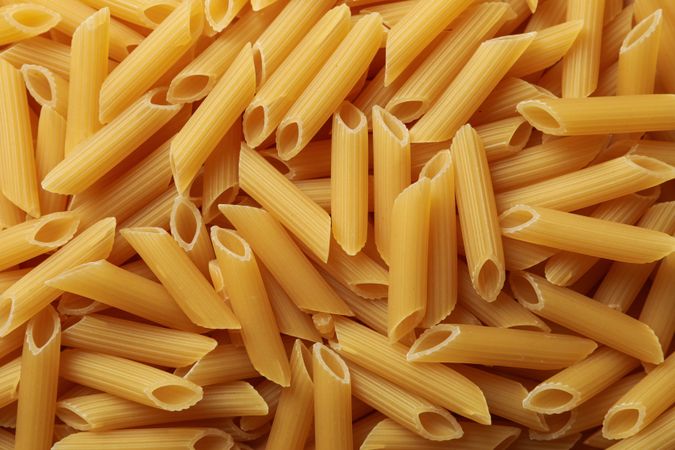 Pasta texture on whole background, top view and close up