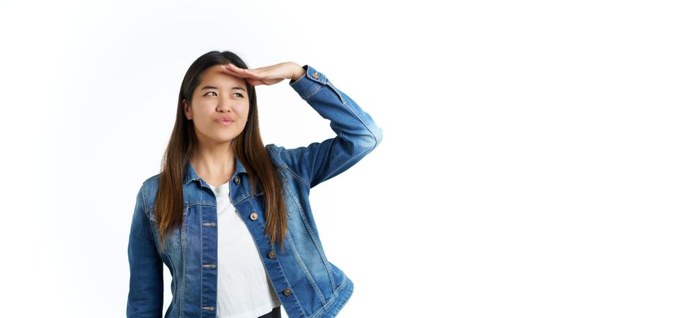 portrait of young asian woman looking away with hand on forehead