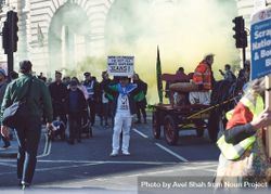 London, England, United Kingdom - March 19 2022: Smoke emerges from crowd at protest 4dzra0