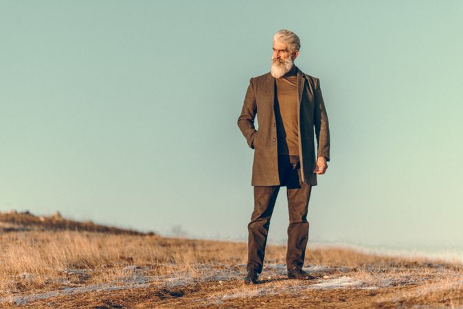 Man in brown coat standing