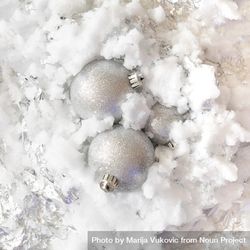 Silver Christmas baubles on snowy background bGrgx4