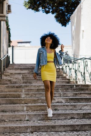 Stylish female standing on stairs outdoors