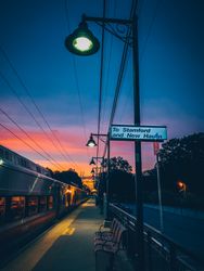 Bench near train during early evening in Village of Pelham, New York, United States 4372j4