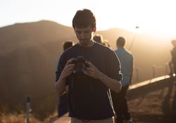 Man holding camera on hill