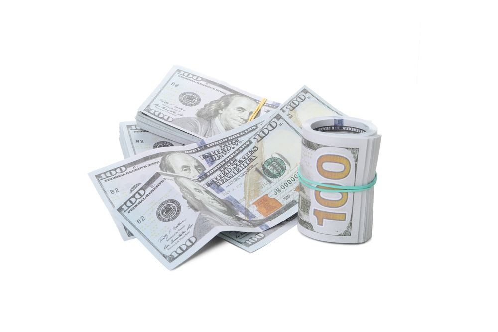 Stacks of American cash money, isolated on light background