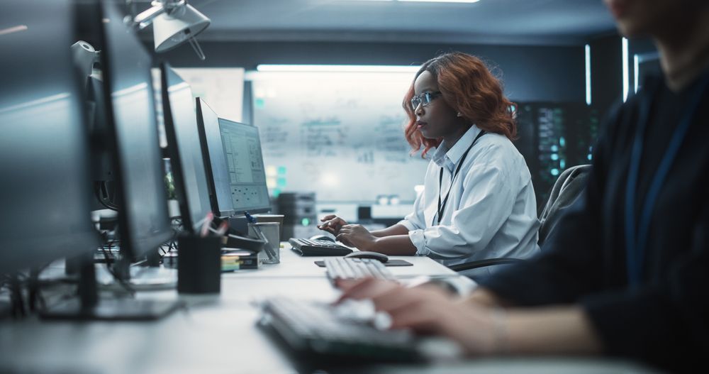 Portrait of a Thoughtful Black Female Engineer Working on Computer in a Technological Office Environment.