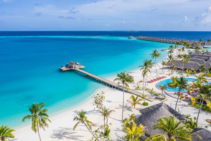 Shot of beach resort in the Maldives with a long pier and overwater bungalows
