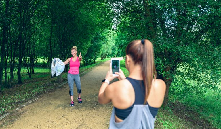 Female taking picture of a friend after plogging
