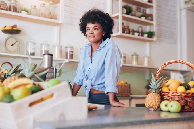 Portrait of attractive young woman standing at juice bar counter
