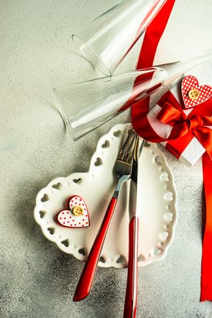 Valentine's Day themed dinner setting with heart shaped plate and gift box