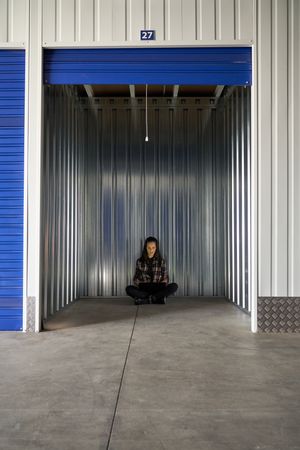 Woman sitting in self storage