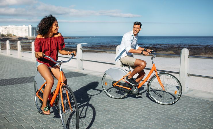 Tourist couple riding around the city on bicycles