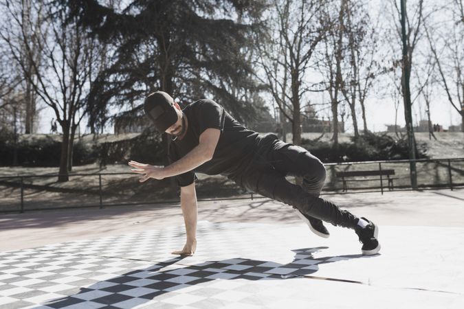 Man dancing break dance in park