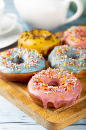 Delicious assorted colorful donuts on the table.