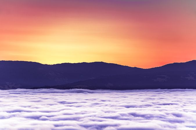 Cliffs and clouds under bright colorful sunset